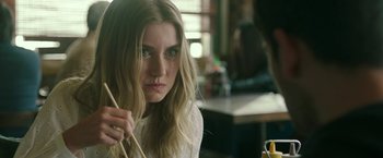 Movie still from “Life Itself” (2018), directed by Dan Fogelman – A beautiful young lady holding chopsticks in a restaurant; Close Up shot, Over the shoulder angle