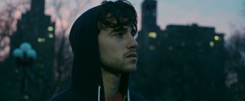 Movie still from “Life Itself” (2018), directed by Dan Fogelman – A young man with a black hooded sweatshirt; Close Up shot, Low angle