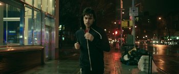 Movie still from “Life Itself” (2018), directed by Dan Fogelman – A man is running down the street at night; Medium shot, Low angle