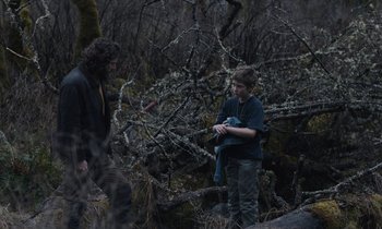 Movie still from “Light of My Life” (2019), directed by Casey Affleck – Two people standing in the woods looking at each other; Wide shot, Over the shoulder angle