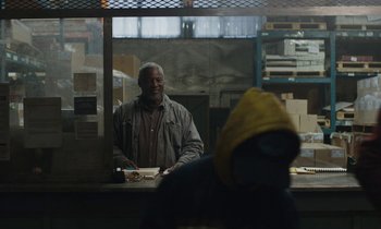Movie still from “Light of My Life” (2019), directed by Casey Affleck – An older man standing behind a counter in a warehouse; Medium shot, Over the shoulder angle