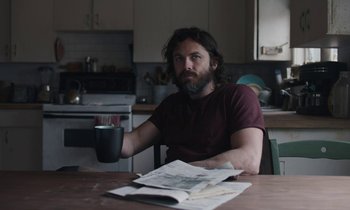 Movie still from “Light of My Life” (2019), directed by Casey Affleck – A man sitting at a table with a cup of coffee; Medium shot, Low angle