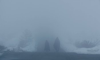 Movie still from “Light of My Life” (2019), directed by Casey Affleck – A couple of people walking down a street in the fog; Extreme Wide shot, Low angle