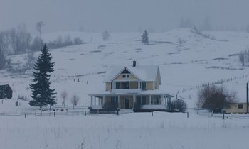 Movie still from “Light of My Life” (2019), directed by Casey Affleck – A house in the middle of a snow covered field; Extreme Wide shot, Low angle