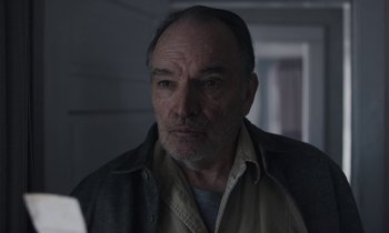 Movie still from “Light of My Life” (2019), directed by Casey Affleck – An older man is looking at the camera in a dark room; Close Up shot, Low angle