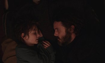 Movie still from “Light of My Life” (2019), directed by Casey Affleck – A man and a boy looking at one another; Close Up shot, Overhead angle