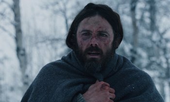 Movie still from “Light of My Life” (2019), directed by Casey Affleck – A man with a beard wrapped up in a blanket; Close Up shot, Low angle