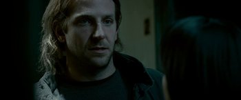 Movie still from “Limitless” (2011), directed by Neil Burger – A person wearing glasses and a jacket; Close Up shot, Over the shoulder angle