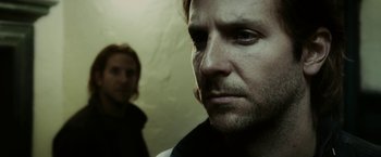 Movie still from “Limitless” (2011), directed by Neil Burger – A man standing next to another man in a room; Close Up shot, Over the shoulder angle