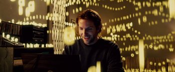 Movie still from “Limitless” (2011), directed by Neil Burger – A man sitting in front of a computer in a room; Medium shot, Low angle