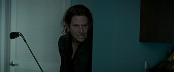 Movie still from “Limitless” (2011), directed by Neil Burger – A man with long brown hair and a black shirt; Close Up shot, Over the shoulder angle