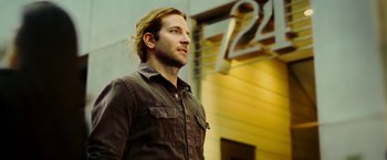 Movie still from “Limitless” (2011), directed by Neil Burger – A person wearing a brown shirt; Close Up shot, Low angle