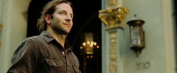 Movie still from “Limitless” (2011), directed by Neil Burger – A person looking up at a building; Close Up shot, Low angle