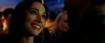 Movie still from “Limitless” (2011), directed by Neil Burger – A woman's face at an event; Close Up shot, Over the shoulder angle