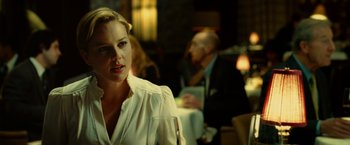 Movie still from “Limitless” (2011), directed by Neil Burger – A woman sitting at a table with a glass of wine; Close Up shot, Over the shoulder angle