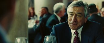 Movie still from “Limitless” (2011), directed by Neil Burger – A man sitting at a table with a glass of wine; Close Up shot, Over the shoulder angle