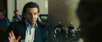 Movie still from “Limitless” (2011), directed by Neil Burger – A man in a suit in a room; Close Up shot, Over the shoulder angle
