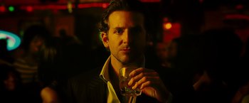 Movie still from “Limitless” (2011), directed by Neil Burger – A person holding a glass of water; Close Up shot, Low angle