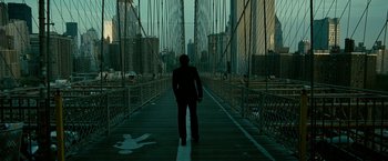 Movie still from “Limitless” (2011), directed by Neil Burger – A man is standing on a bridge in the dark; Wide shot, High angle