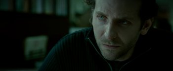 Movie still from “Limitless” (2011), directed by Neil Burger – A man's face in a dark room; Close Up shot, Over the shoulder angle