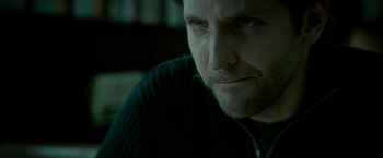 Movie still from “Limitless” (2011), directed by Neil Burger – A man's face in a dark room; Close Up shot, Over the shoulder angle