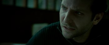 Movie still from “Limitless” (2011), directed by Neil Burger – A man's face in a dark room; Close Up shot, Over the shoulder angle