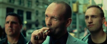 Movie still from “Limitless” (2011), directed by Neil Burger – A man in a suit smoking a cigarette; Close Up shot, Low angle
