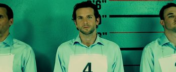 Movie still from “Limitless” (2011), directed by Neil Burger – A man in a blue shirt and a white number four on his shirt; Close Up shot, High angle