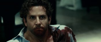Movie still from “Limitless” (2011), directed by Neil Burger – A person with a bloody shirt on; Close Up shot, Over the shoulder angle