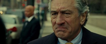 Movie still from “Limitless” (2011), directed by Neil Burger – An older man wearing a suit and tie looking sad; Close Up shot, Over the shoulder angle