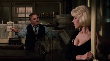 Movie still from “Little Shop of Horrors” (1986), directed by Frank Oz – A man and a woman are in a room; Medium shot, Over the shoulder angle