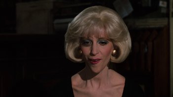 Movie still from “Little Shop of Horrors” (1986), directed by Frank Oz – A woman with blonde hair and blue eye shadow; Close Up shot, Low angle