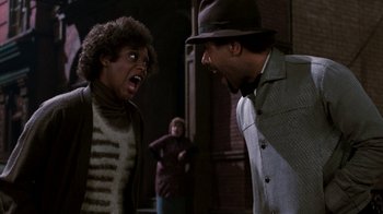 Movie still from “Little Shop of Horrors” (1986), directed by Frank Oz – Two men in a hat and a woman in a hat; Medium shot, Over the shoulder angle