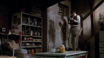 A man standing next to a table in a room