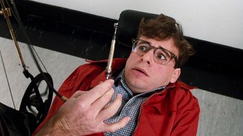 Movie still from “Little Shop of Horrors” (1986), directed by Frank Oz – A man holding a cell phone up to his ear; Close Up shot, Overhead angle