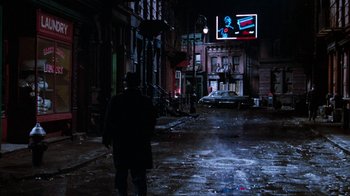 Movie still from “Little Shop of Horrors” (1986), directed by Frank Oz – A man walking down a street at night; Wide shot, Over the shoulder angle