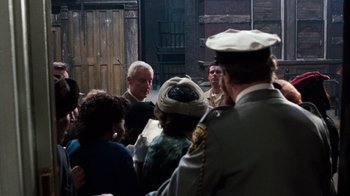 A group of people gathered around a man in a military uniform