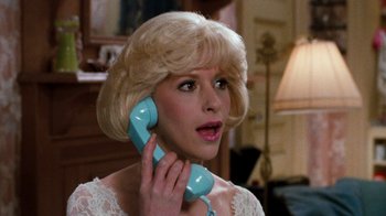 Movie still from “Little Shop of Horrors” (1986), directed by Frank Oz – A woman holding a phone up to her ear; Close Up shot, High angle