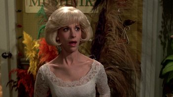 Movie still from “Little Shop of Horrors” (1986), directed by Frank Oz – A woman in a white dress with blonde hair; Close Up shot, Over the shoulder angle