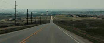 Movie still from “Little Woods” (2018), directed by Nia DaCosta – An empty road going through a rural area; Extreme Wide shot, High angle