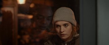 Movie still from “Little Woods” (2018), directed by Nia DaCosta – A woman wearing a hat and a jacket looking at the camera; Close Up shot, Over the shoulder angle