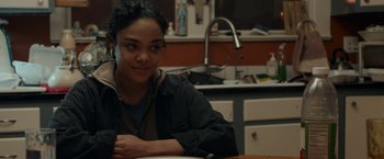 Movie still from “Little Woods” (2018), directed by Nia DaCosta – A woman sitting at a table in front of a plate of food; Close Up shot, Over the shoulder angle