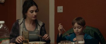 Movie still from “Little Woods” (2018), directed by Nia DaCosta – A woman sitting at a table with a child; Close Up shot, Over the shoulder angle