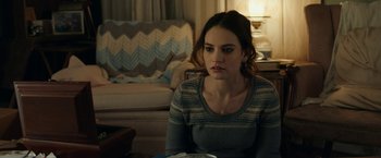 Movie still from “Little Woods” (2018), directed by Nia DaCosta – A beautiful young lady sitting at a table in a living room; Close Up shot, Over the shoulder angle