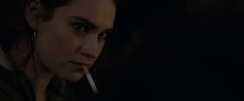 Movie still from “Little Woods” (2018), directed by Nia DaCosta – A woman is holding a cigarette in her mouth; Extreme Close Up shot, Over the shoulder angle
