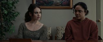 Movie still from “Little Woods” (2018), directed by Nia DaCosta – A woman sitting at a table next to a man; Medium shot, Over the shoulder angle