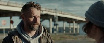 Movie still from “Little Woods” (2018), directed by Nia DaCosta – A person with a bridge in the background; Close Up shot, Low angle