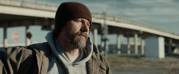 Movie still from “Little Woods” (2018), directed by Nia DaCosta – A man with a beard wearing a brown hat; Close Up shot, Low angle