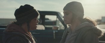 Movie still from “Little Woods” (2018), directed by Nia DaCosta – Two people standing next to each other near a car; Close Up shot, Over the shoulder angle