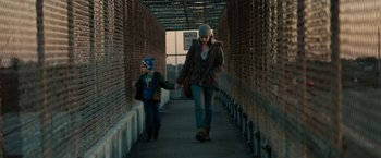 Movie still from “Little Woods” (2018), directed by Nia DaCosta – A woman and a child are walking down a bridge; Medium shot, Low angle